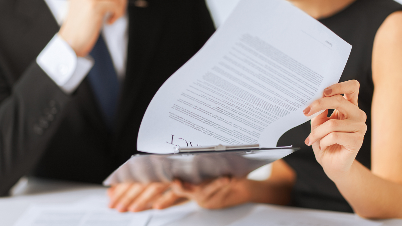 business, office, law and legal concept - picture of man and woman hand signing contract paper
